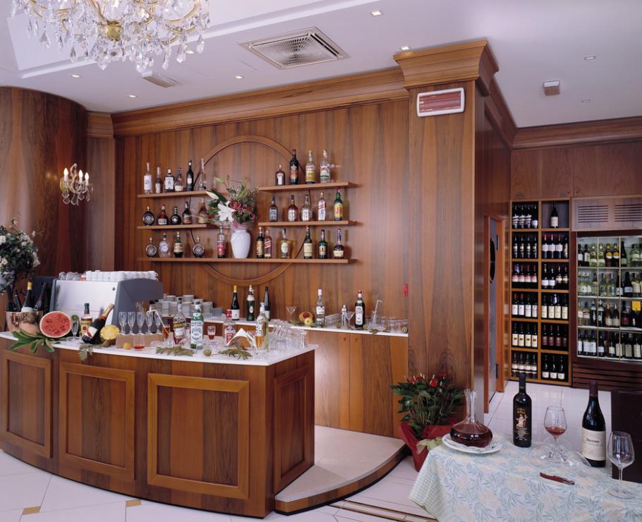 Elegant bar with wines and spirits on wooden shelves.